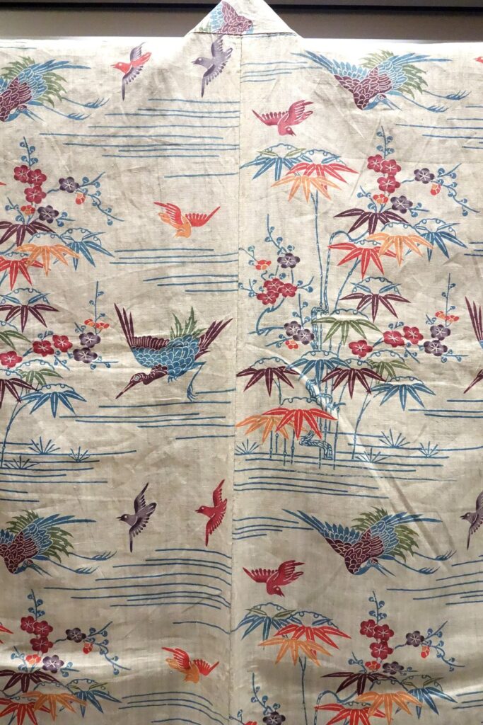 Cream-coloured robe dyed with red and green bamboo, plum blossoms and flying birds above blue wavy lines