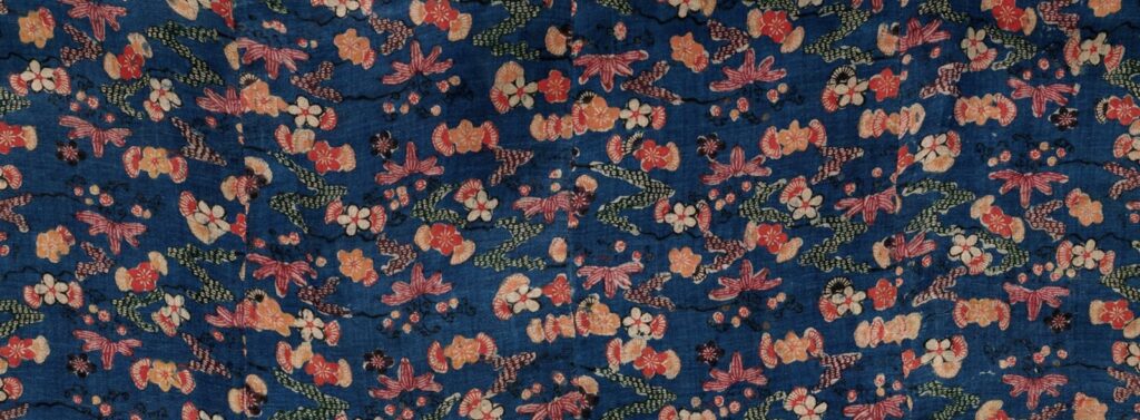Detail of a 19th-century blue bingata kimono with floral motifs