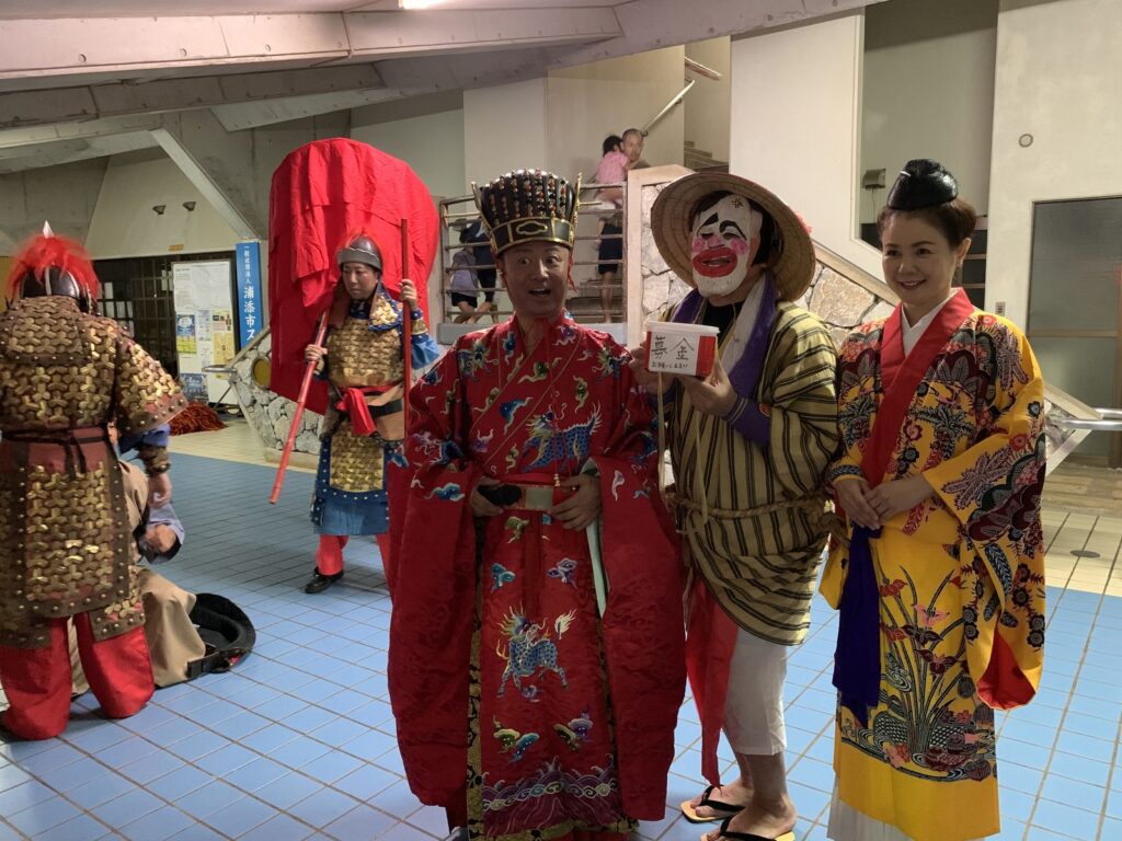 Performers in colourful Ryukyu court-style costumes posing at the Urasoe Tedako Festival